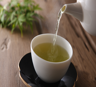 green tea being poured into a white cup - best tea blends concept image