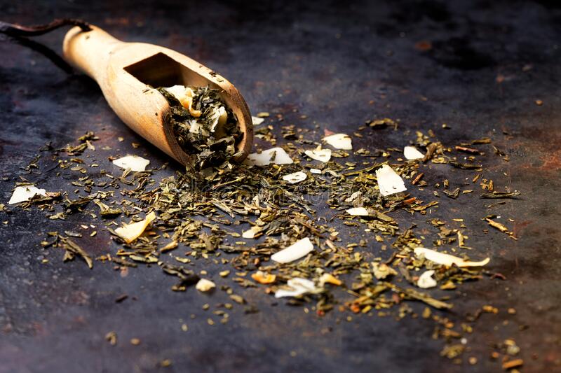 sencha-green-tea-flavored-coconut-shavings-pineapple-citrus-zest-dark-textured-background-banner-selective-focus-201762573