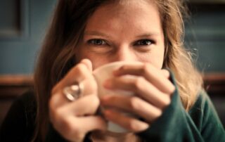 woman drinking tea happy - best tea for mood concept