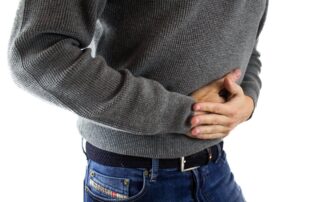 Man holding stomach from pain